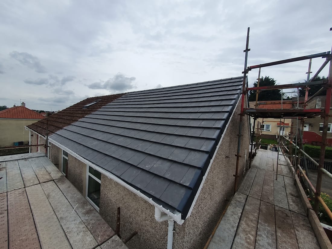 Completed anthracite tiled re-roof on a Reading bungalow with scaffolding still in place