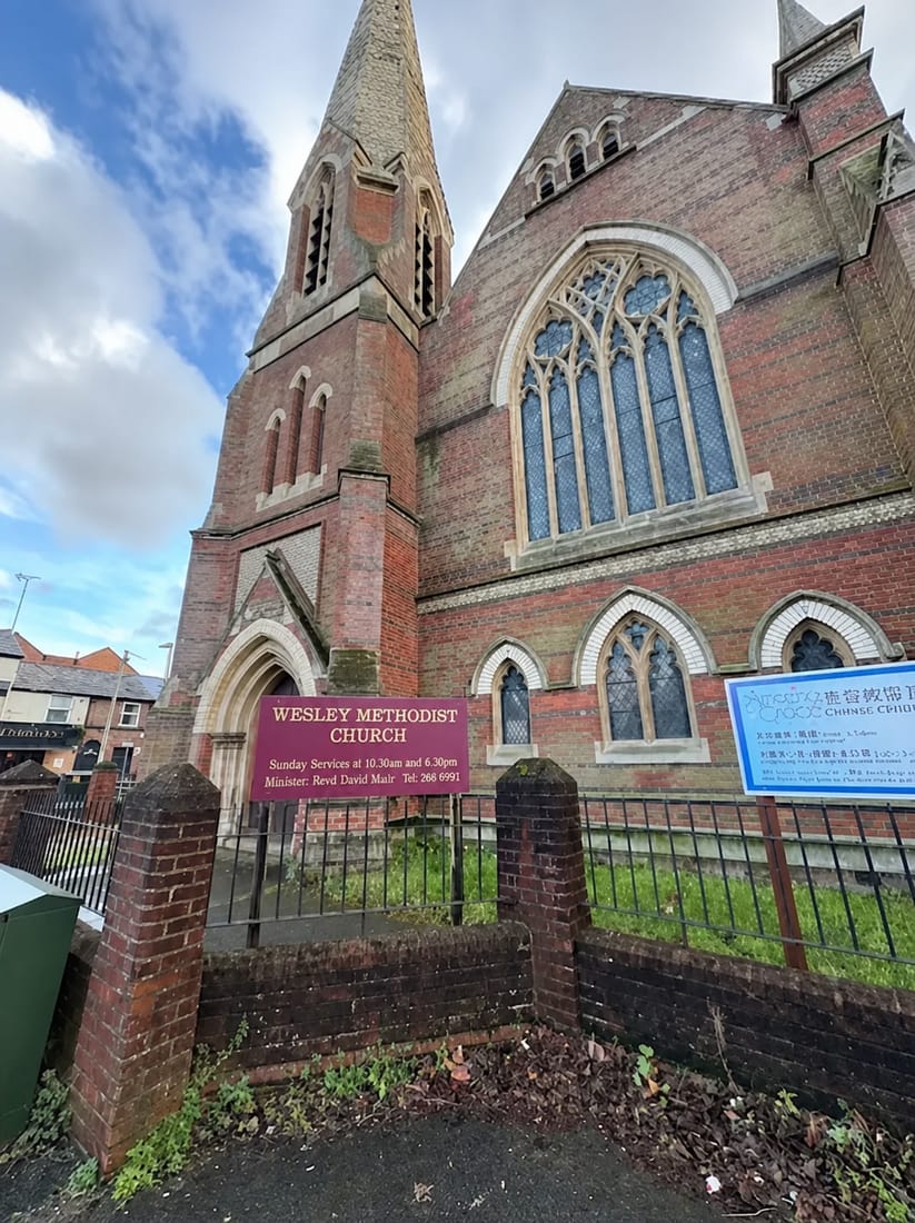 Victorian red brick Methodist church with spire, a commercial roofing project