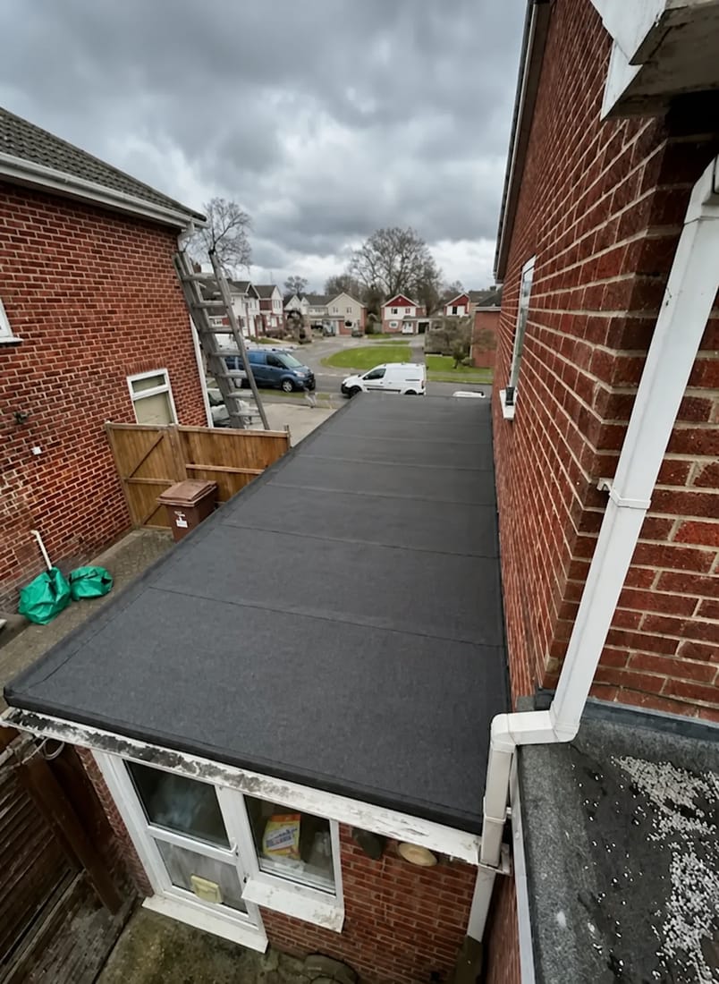 Newly installed flat roof covering on a side extension viewed from above